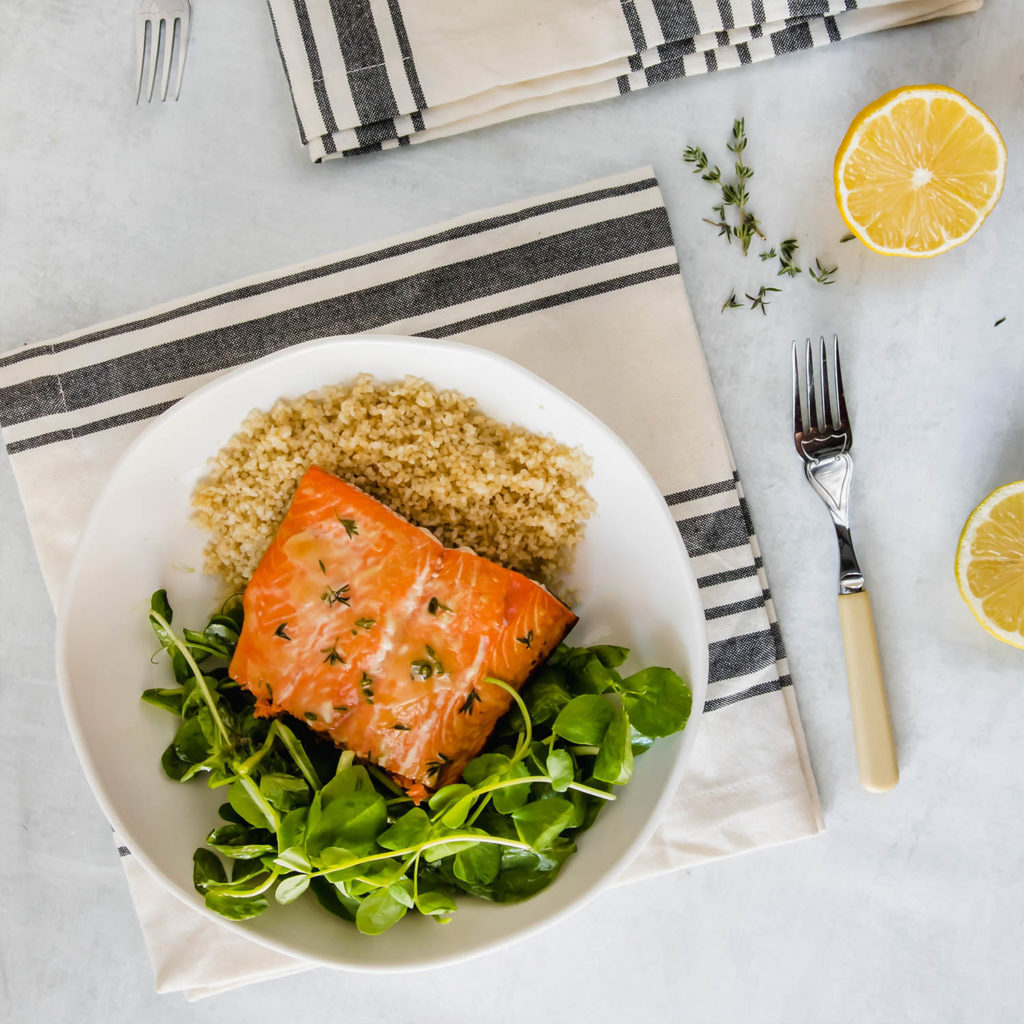 An easy honey mustard thyme salmon recipe including couscous and fresh greens.